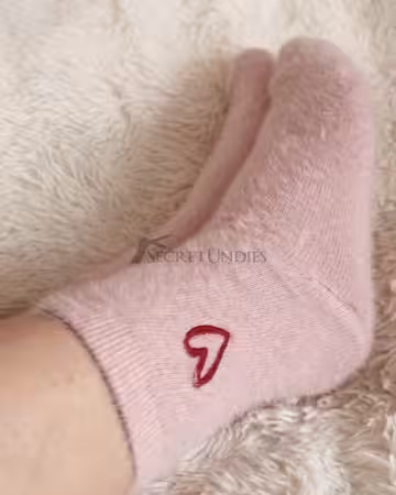 Kuschelige rosa Lieblingssocken, getragen im Bett mit den allerschönsten Gedanken