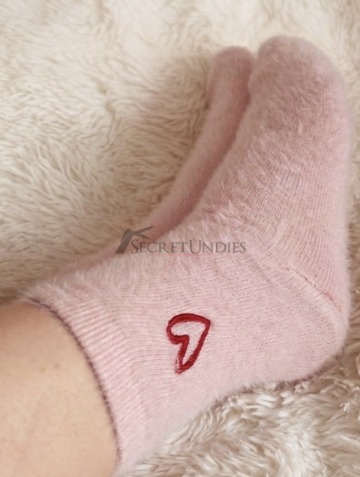 Kuschelige rosa Lieblingssocken, getragen im Bett mit den allerschönsten Gedanken